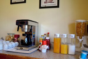 A kitchen counter with a coffee maker, various food items, and condiments. - The Bedford View Guest House (Germiston)
