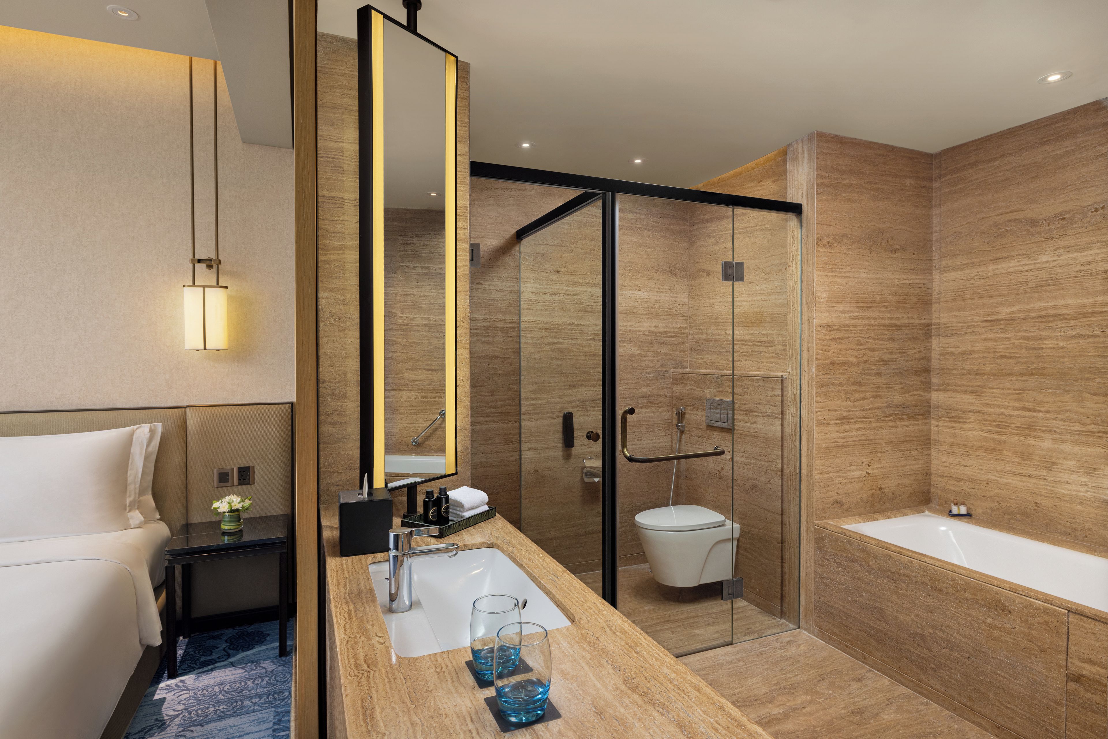 A modern bathroom with a glass shower enclosure, a white toilet, and a bathtub.