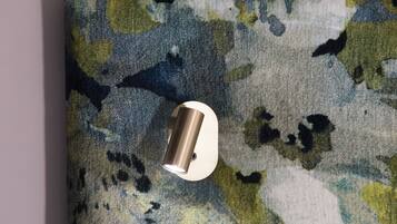 A textured wall with a metallic light fixture.