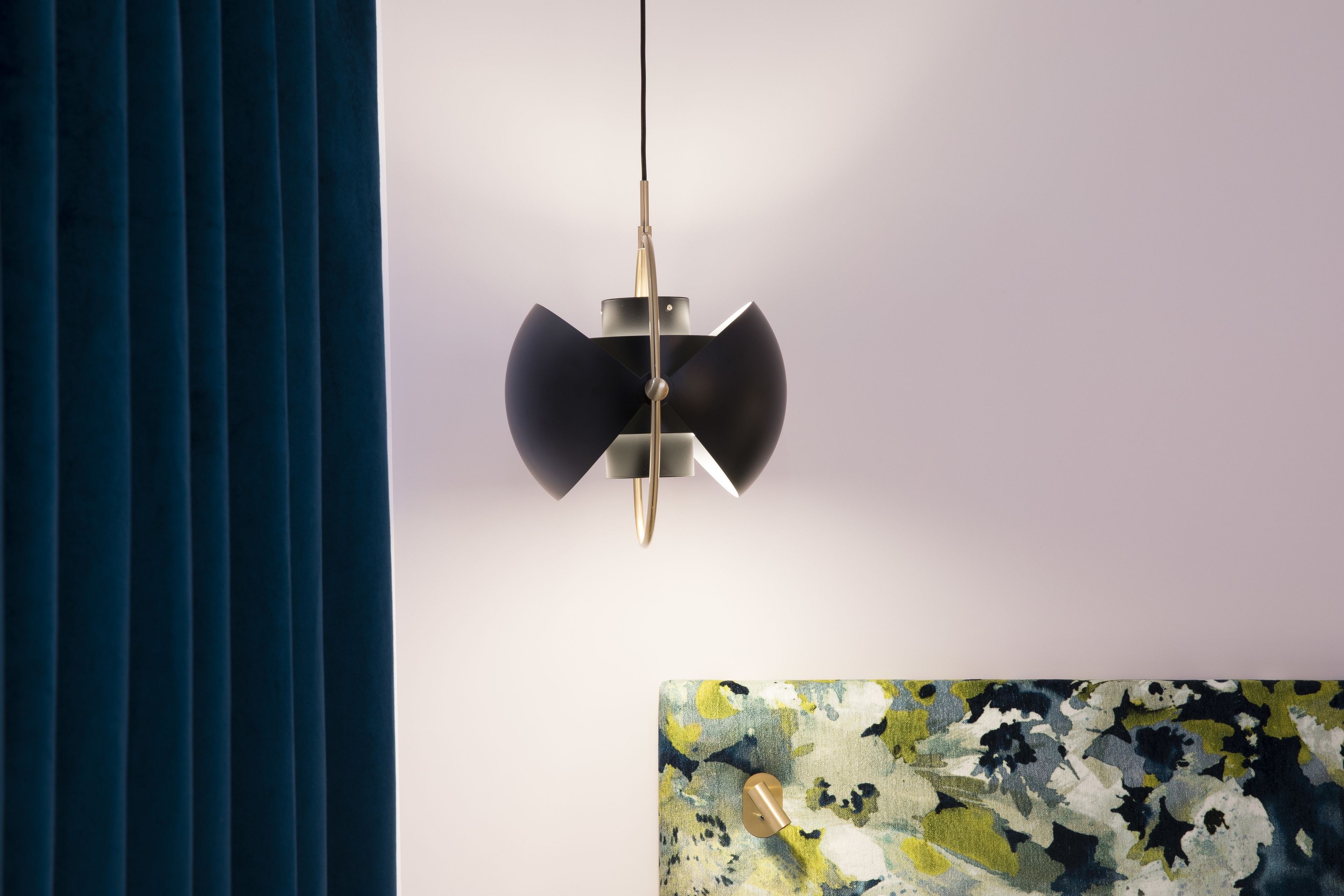A modern pendant light fixture with a metallic finish and a geometric design, hanging from a ceiling.