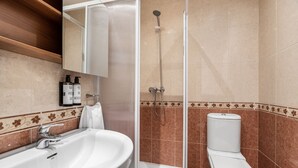 A bathroom with a sink, toilet, and shower. - Apartamentos El Cid (Burgos)