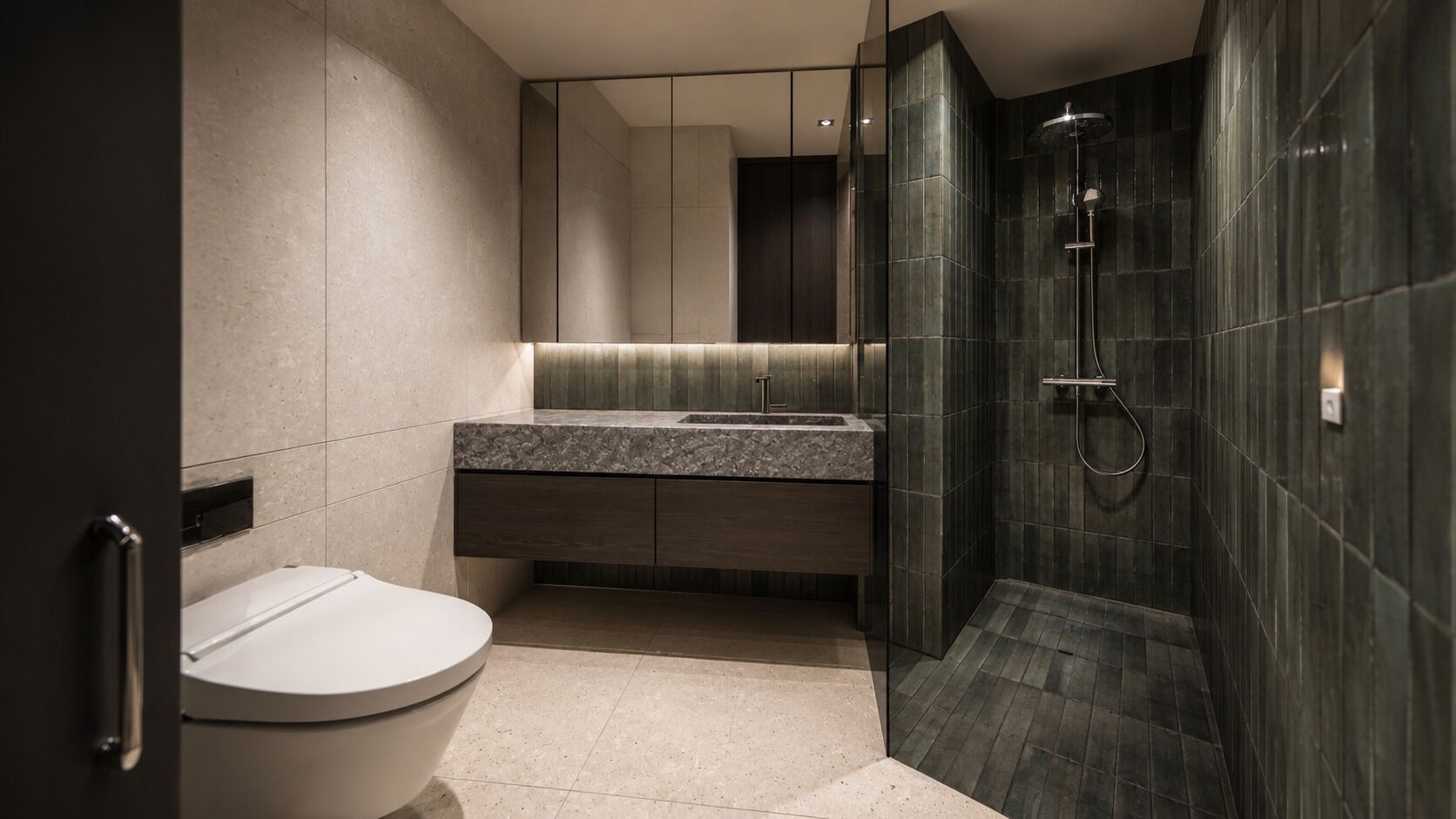 A modern bathroom with a toilet, sink, and shower.