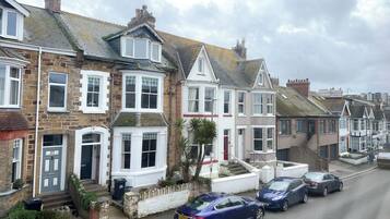 A row of terraced houses with distinct architectural styles, including bay windows and pitched roofs.