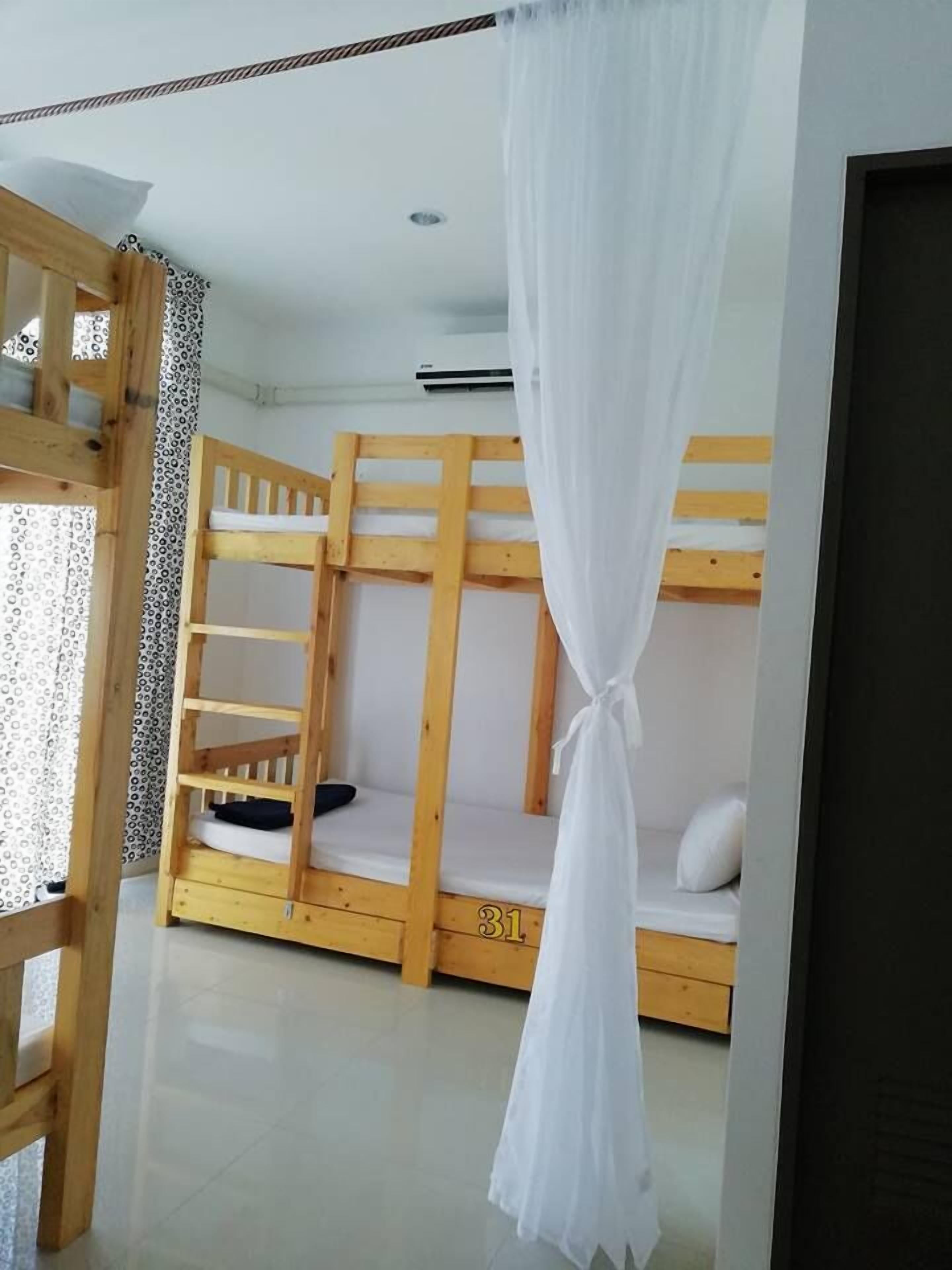 A room with bunk beds, a wooden ladder, and a number '31' on the wall.