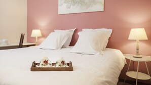 A neatly made bed with white linens, a tray with decorative items, and two bedside lamps on either side. - B&B Le Verger du Pierroy (Léglise)