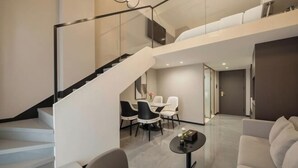A modern interior with a staircase, a dining area, and a seating area. - Zhangjiakou International Hotel (Building B ) (Zhangjiakou)