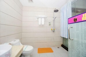 A small bathroom with a toilet, a shower, and a glass door with a bamboo pattern. - Jingxin Business Hotel (Xishan Road Branch) (Guilin)