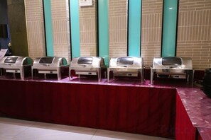 A row of buffet-style food dispensers on a table with a red tablecloth. - Heyuan Boutique Hotel (Shaoguan High-speed Railway Station) (Shaoguan)