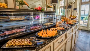 A buffet with various food items and a decorative vase.