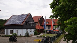 A building with solar panels, a sign reading "Landgasthaus Seyssinshof," and a traditional European architectural style. - Landgasthaus zum Seysingshof (Heldburger Unterland)