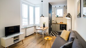 Een modern appartement met een woonkamer, eetgedeelte en keuken.