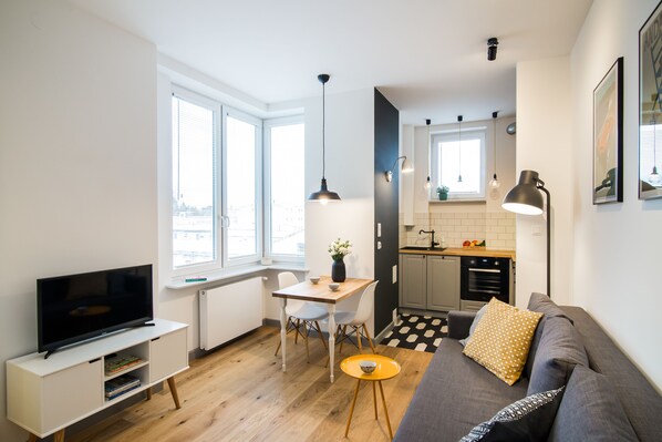 Een modern appartement met een woonkamer, eetgedeelte en keuken.