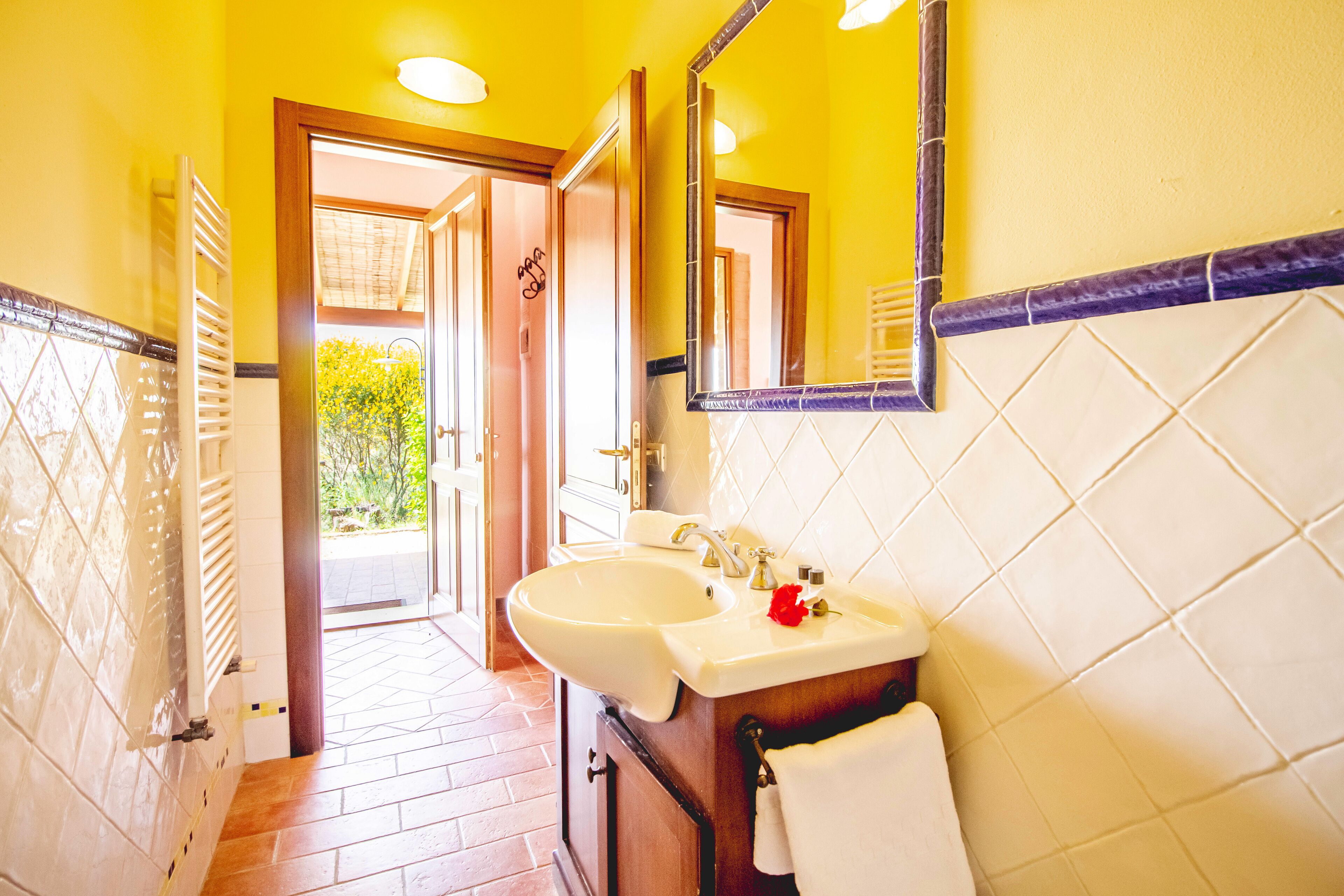 A bathroom with two sinks, a mirror, and a towel rack.