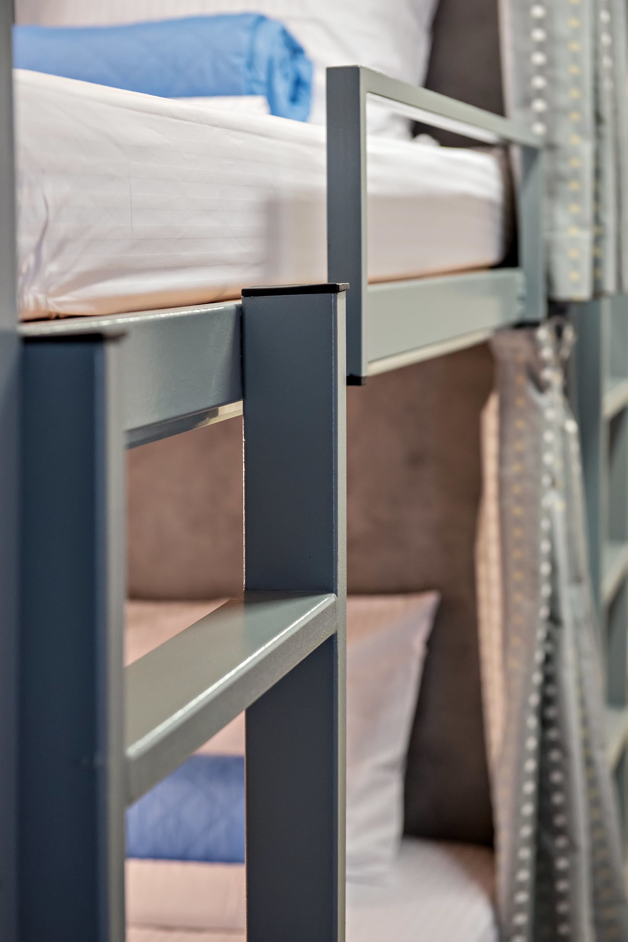 A bunk bed with a metal frame and a mattress.