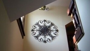 A spiral metal wall decor in a hallway. - The Sea Gypsy (Wildwood)