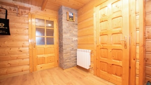 A wooden interior with two doors, a stone pillar, and a white radiator. - Pod Hawraniem (Bukowina Tatrzanska)