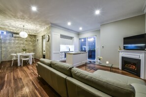Aloha Luxury Central Apartment (4) | Living area | 50-inch flat-screen TV with premium TV channels, Smart TV, fireplace - Aloha Luxury Central Apartments (Mount Gambier)