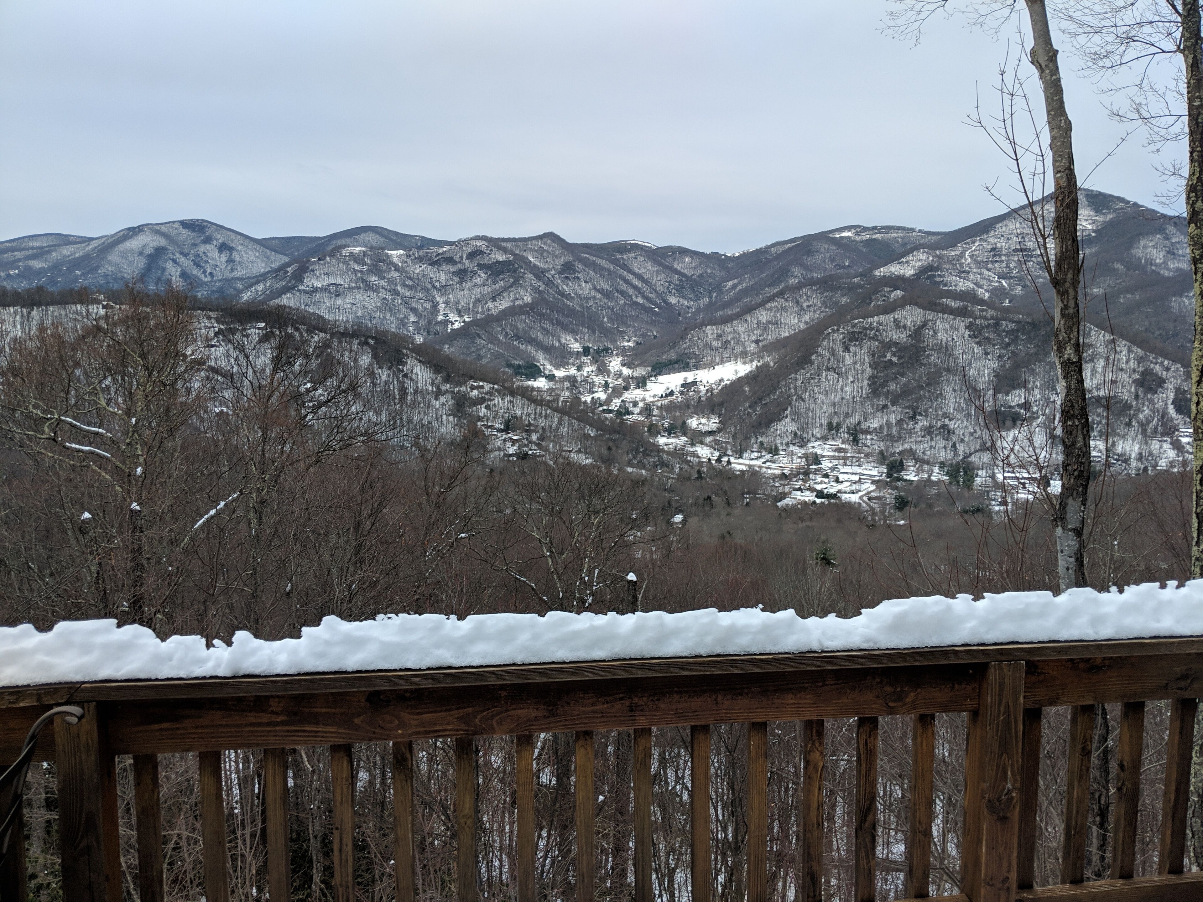 A wooden deck with a snowy landscape in the background.