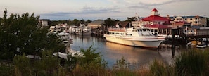 A marina with boats docked, a building with a red roof, and a waterfront view. - Bear Trap Dunes * 4BR Luxury Resort home (Ocean View)