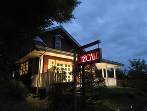 A house with a lit sign reading "L'ESCALÉE" and a covered porch. - Japan Nikko Pension L'escale (Nikko)