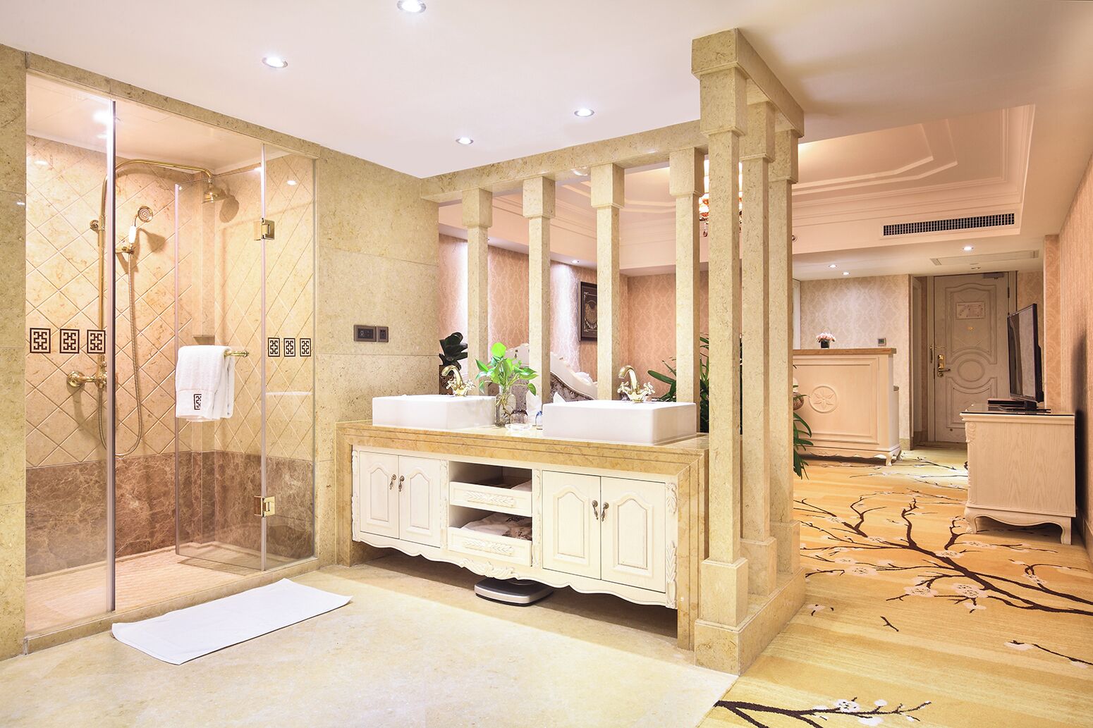 A luxurious bathroom with a glass-enclosed shower, a double sink vanity, and a large mirror.