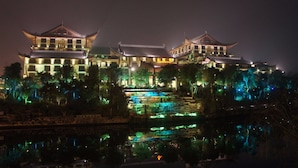A traditional building with multiple levels and a central water feature.