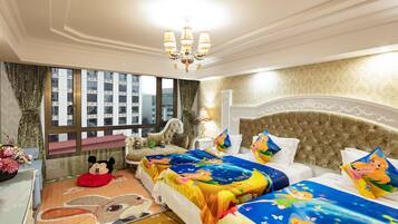 A hotel room with two beds, a large window with a city view, a chandelier, and a Mickey Mouse plush toy on the floor.