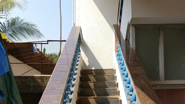 A staircase with blue balusters and a handrail, leading to a building entrance. - Villa Mer (Baga)