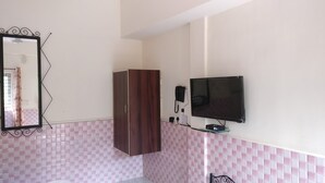 A bathroom with a wooden wardrobe, a wall-mounted telephone, and a television. - Villa Mer (Baga)