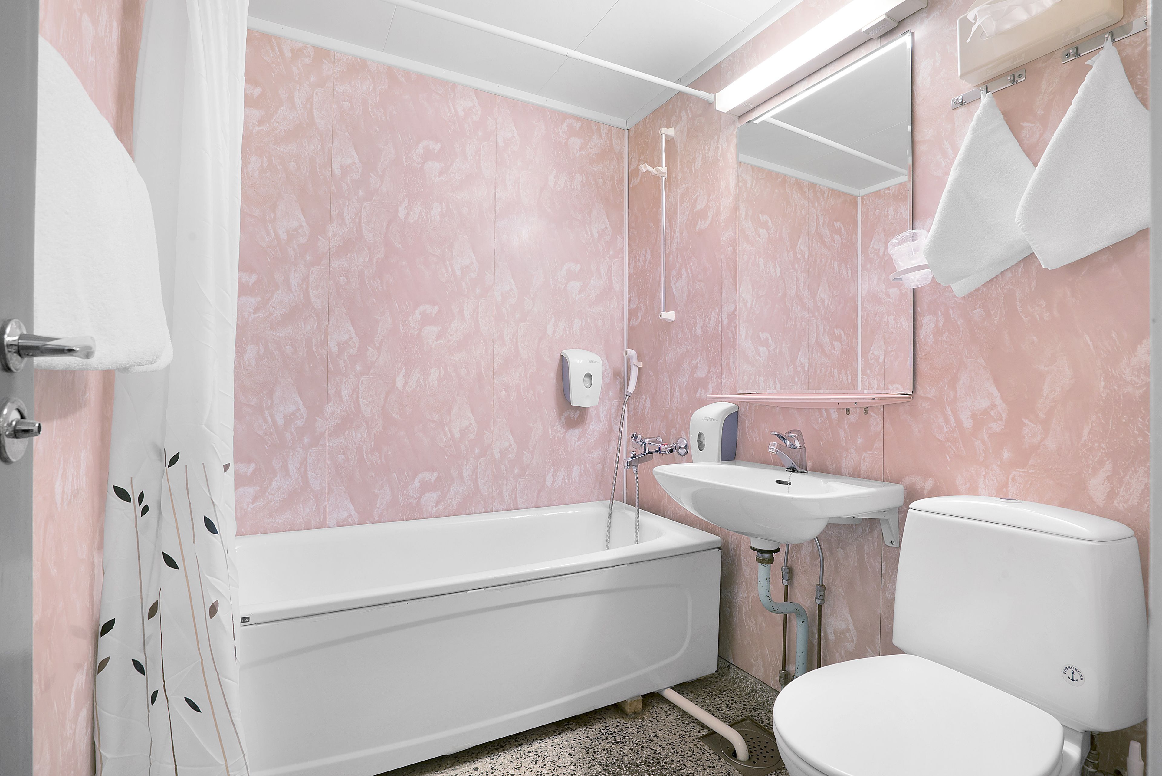 A bathroom with a bathtub, sink, and toilet.