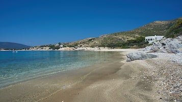 Una playa cerca, sillas reclinables de playa, sombrillas