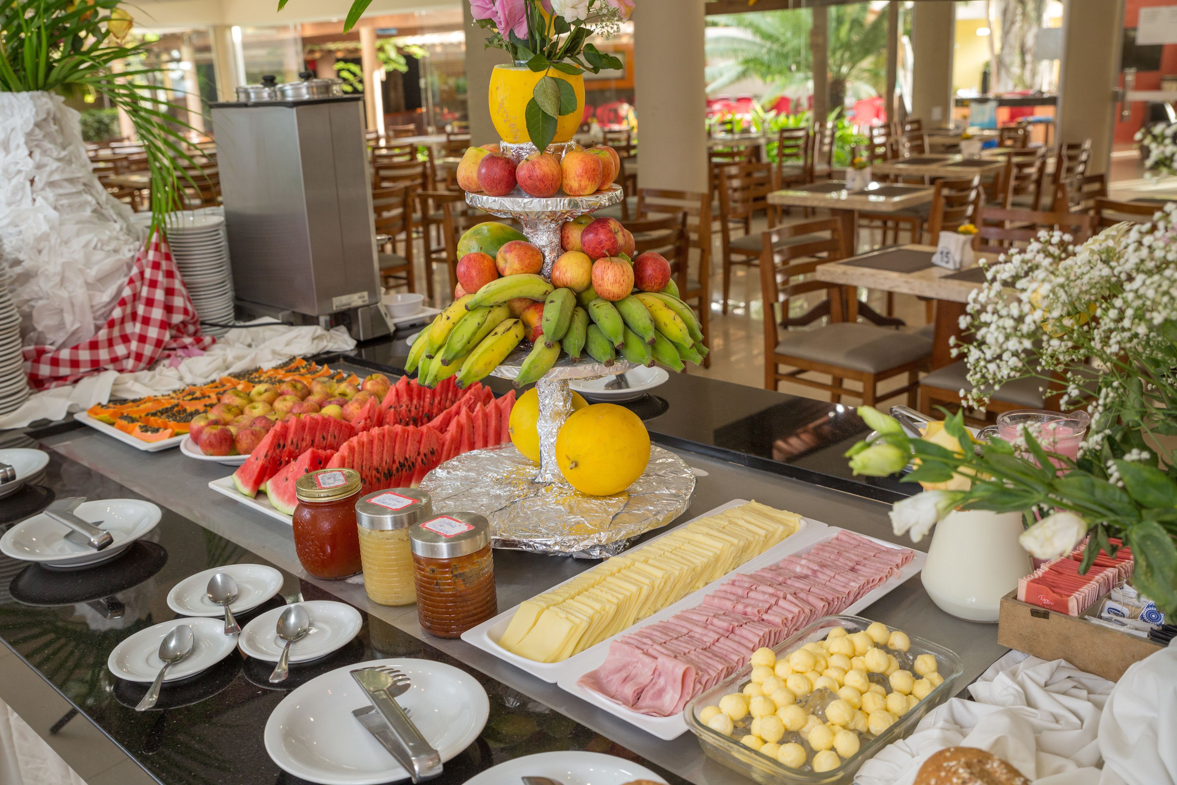 A buffet with various food items including fruits, vegetables, and condiments.