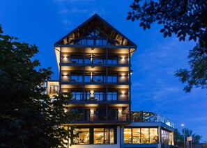 A multi-story hotel with balconies, large windows, and a dining area visible. - Alojamientos Ainsa Sanchez (Ainsa)