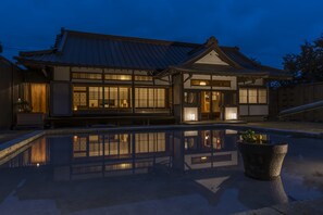 A traditional Japanese building with a reflective pool in front. - Bettei Himawari (Nikko)