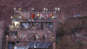 A multi-story building with balconies, air conditioning units, and solar panels. - Toubkal Garden Hotel (Asni)