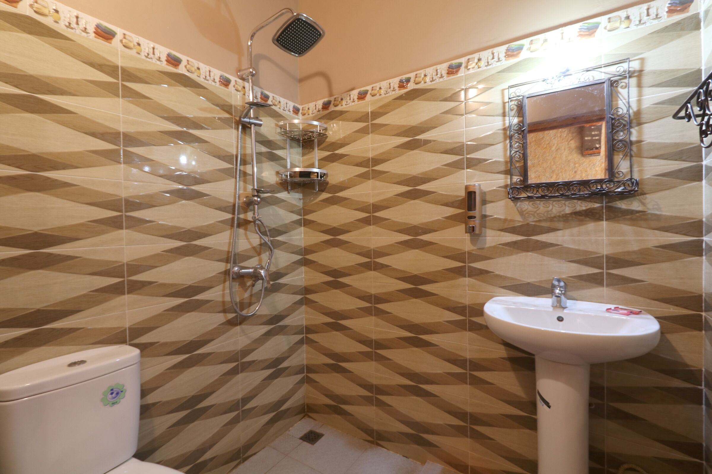 A bathroom with a shower, toilet, and sink.