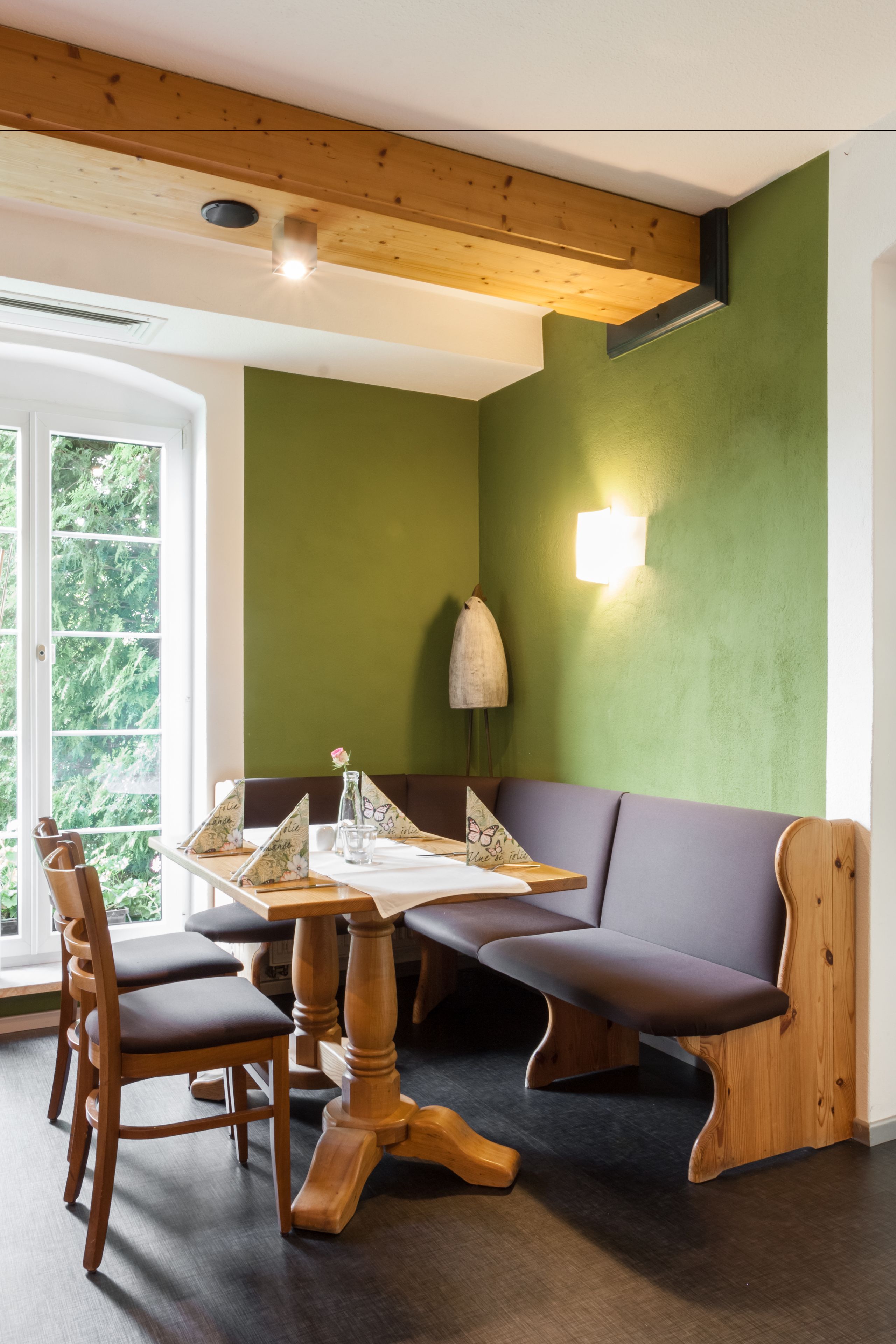 A dining area with a wooden table, chairs, and a bench.
