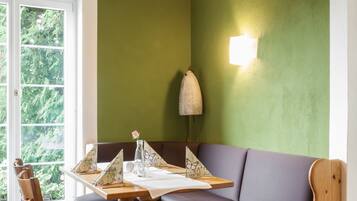 A dining area with a wooden table, chairs, and a bench.
