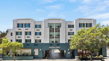 A modern hotel with a flat facade, multiple windows, and a clear entrance.