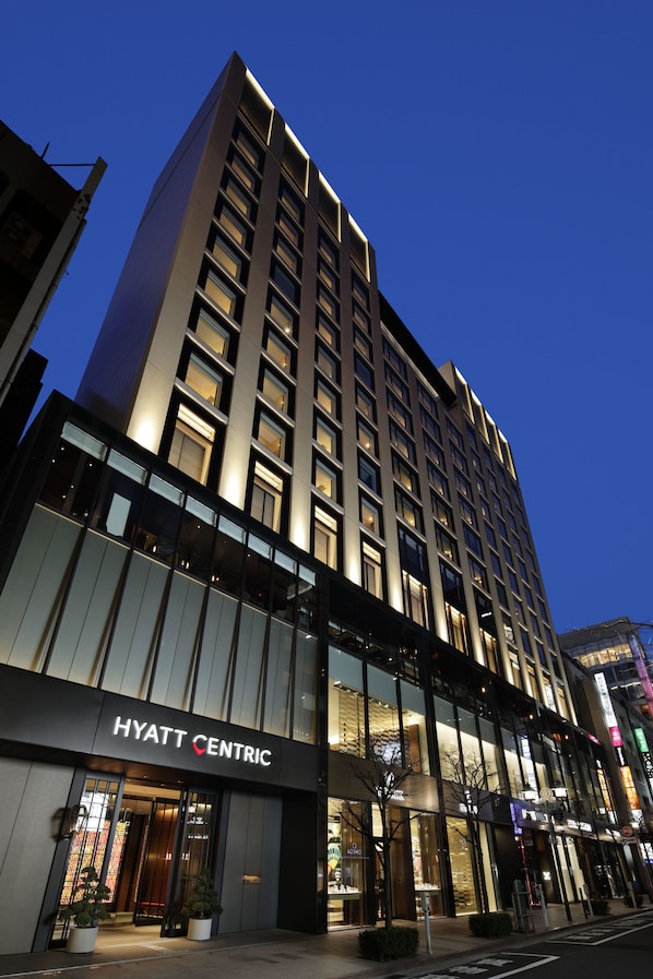 A modern hotel building with a prominent sign reading "HYATT CENTRIC".