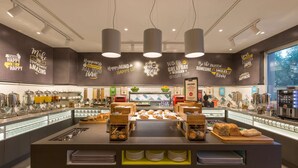 A breakfast buffet with various food items and a wall with motivational quotes. - Hampton by Hilton Rome East (Rome)
