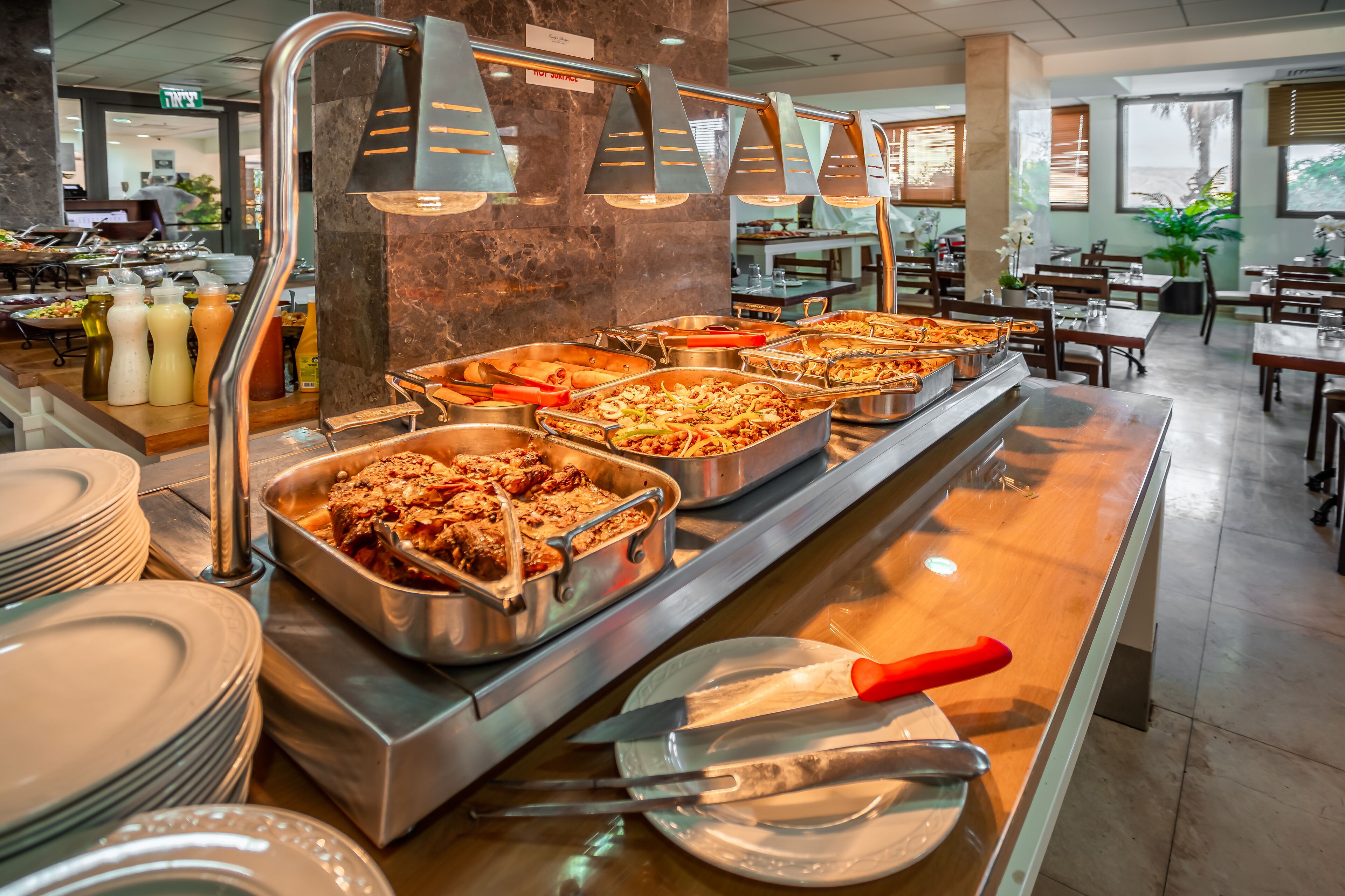 Un'area buffet con diverse postazioni, inclusa un'ampia scelta di piatti e bevande.