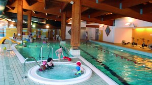 An indoor swimming pool with wooden beams, a hot tub, and exercise bikes. - VVF Val-Cenis Haute-Maurienne (Val-Cenis)