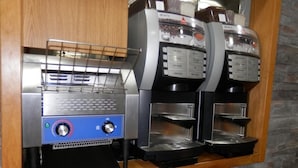 A coffee machine with a digital display and a coffee dispenser. - Les Neus (Pas de la Casa)