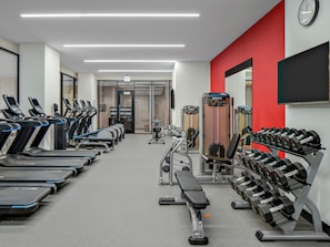 A gym with treadmills, dumbbells, and weight machines. - Home2 Suites by Hilton Chicago McCormick Place (Chicago)