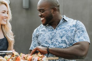 A person grilling food outdoors. - Home2 Suites by Hilton Chicago McCormick Place (Chicago)