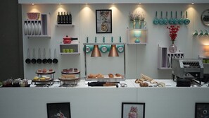 A kitchen counter with various utensils, cookware, and food items. - Fairfield by Marriott Amritsar (Amritsar)