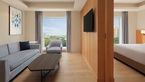 A modern hotel room with a sofa, armchair, and a bed. - Fairfield by Marriott Amritsar (Amritsar)