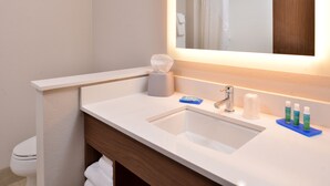 A bathroom with a white sink, a mirror, and toiletries. - Holiday Inn Express Early by IHG (Early)