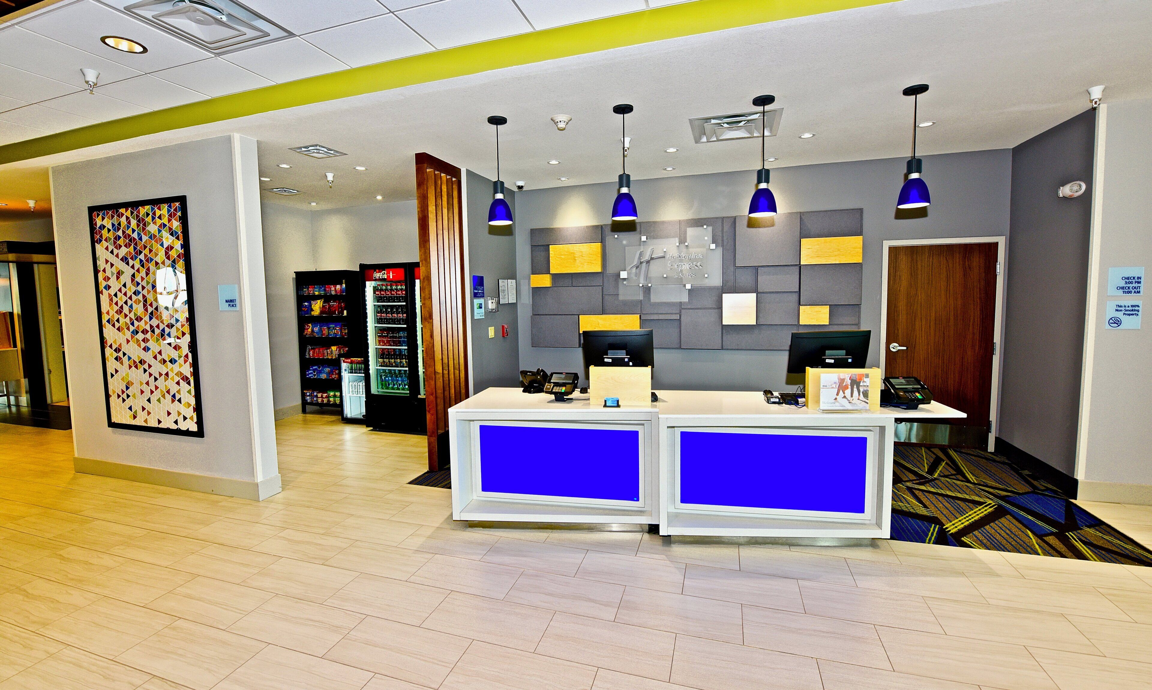 A reception area with a counter, vending machines, and a security camera.